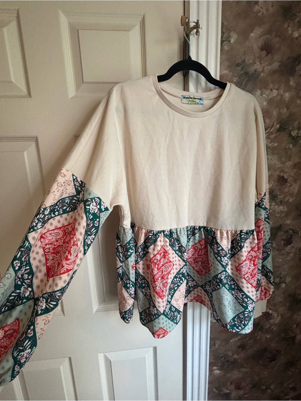 Cream Patchwork Peplum Sweatshirt with Red & Teal Accents
